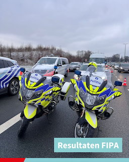 Two Belgian police motorcycles with yellow-blue livery on a highway, police vehicles in background