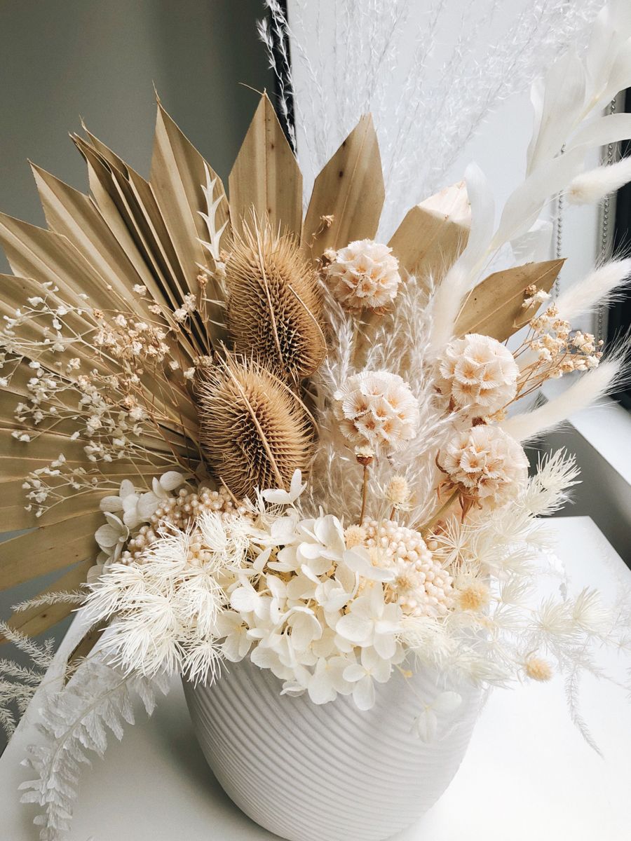 Dried flower arrangement with pampas grass and neutral blooms in white vase