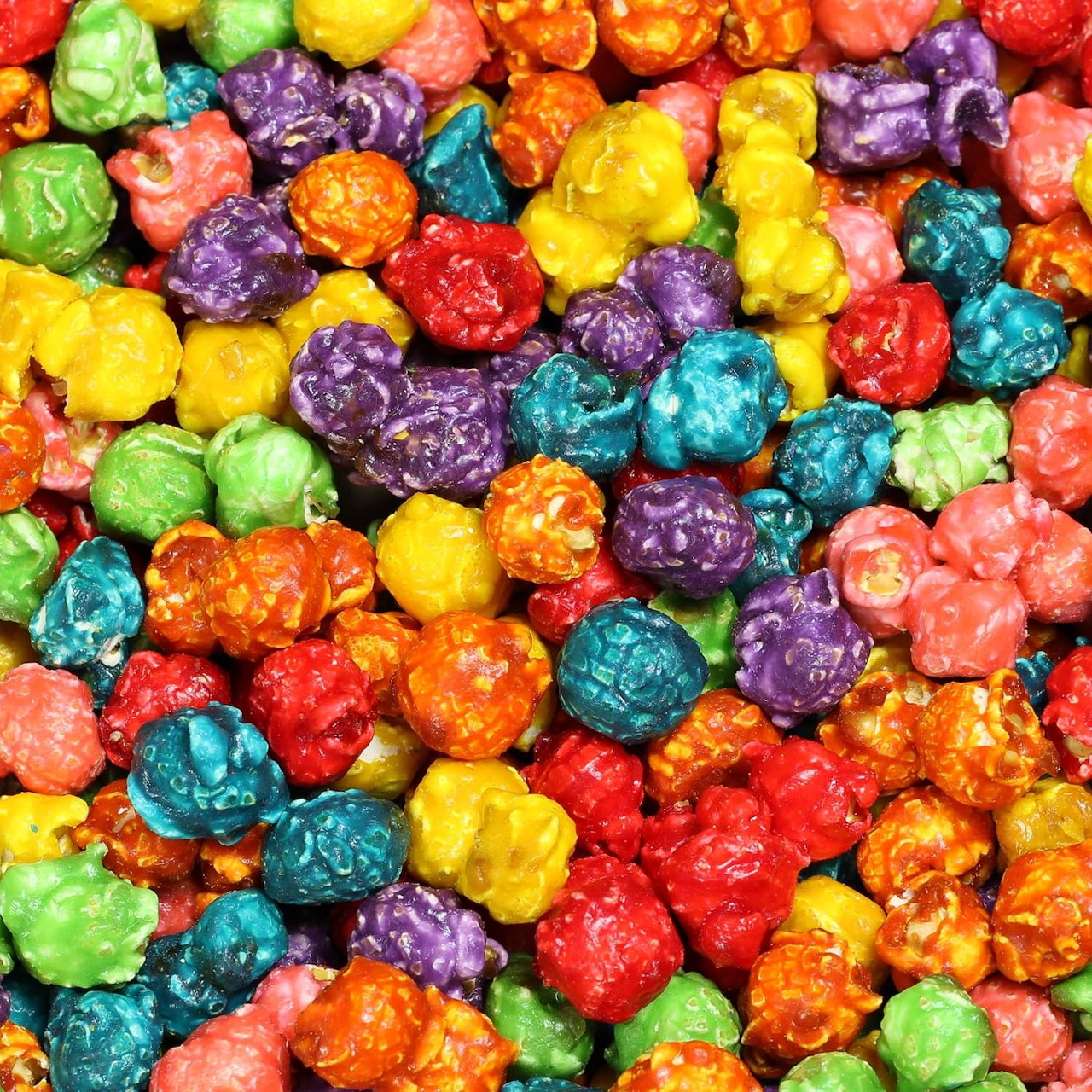Close-up of rainbow colored candy popcorn in many bright colors filling the frame