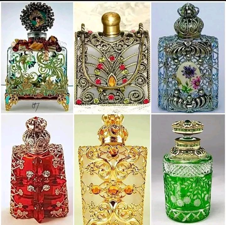 Six ornate vintage perfume bottles with jeweled metal caps and colorful glass bodies