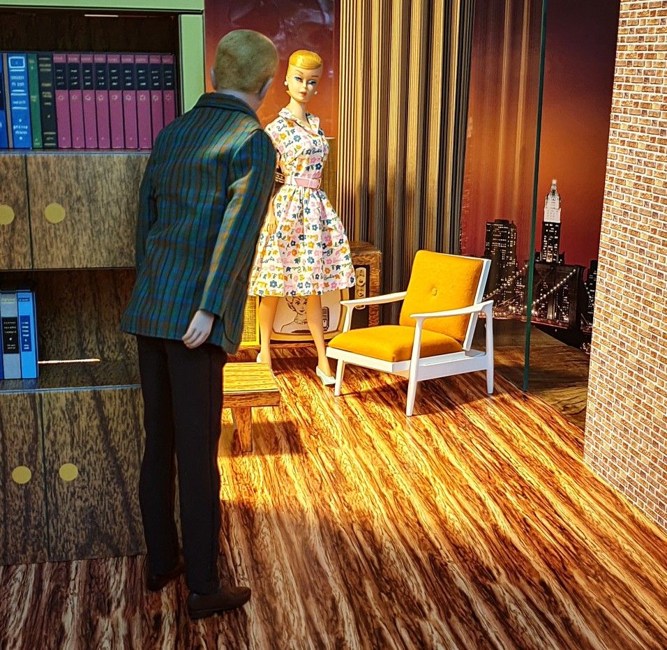 Stylized room with a man peeking at a woman in a patterned dress near a yellow chair