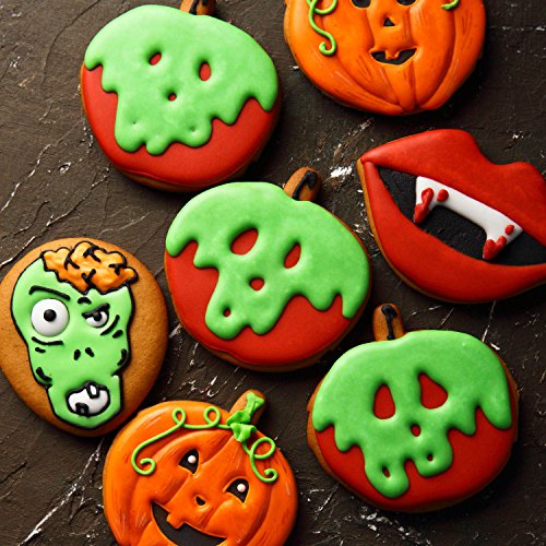 Assortment of Halloween decorated cookies including pumpkins, zombie face, poison aples, and vampire lips