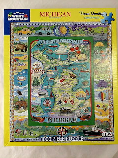 Illustrated Michigan state map with landmarks, animals, and symbols in vintage collage style