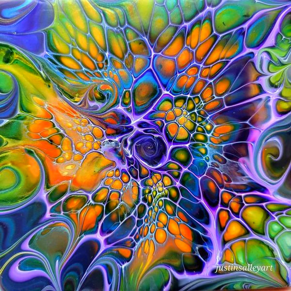 Colorful abstract acrylic pour with swirling spiral patterns in blue, yellow, orange, and purple hues