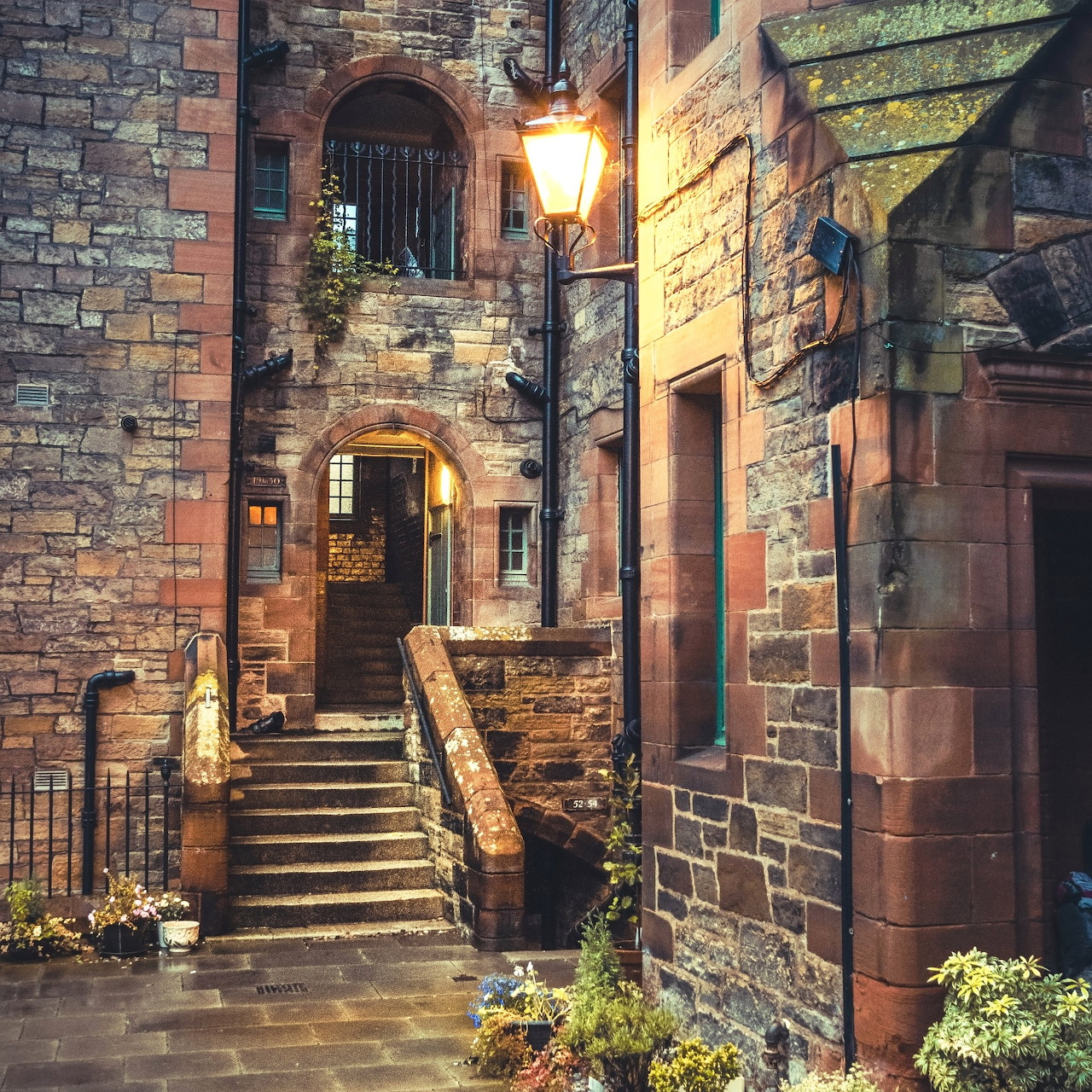 Stone stairway and historic buildings in Dean Village, Edinburgh, lit by warm streetlight