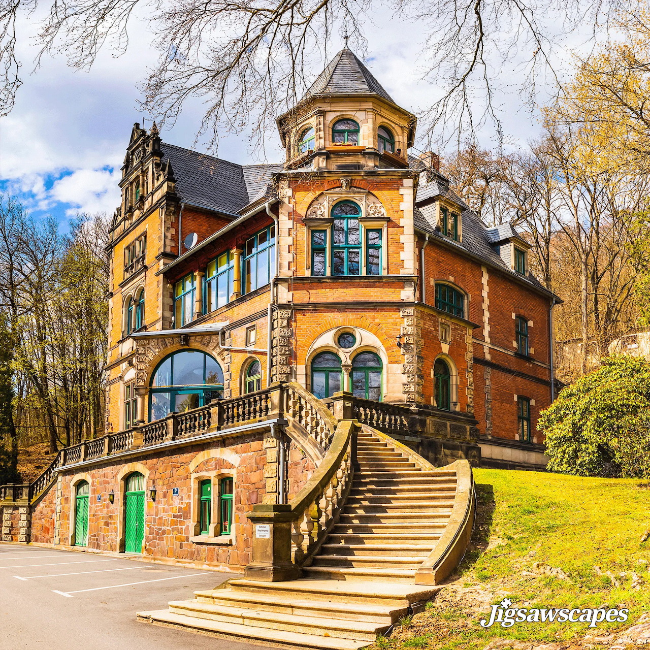 Orange historic villa with turret and grand staircase in autumn setting