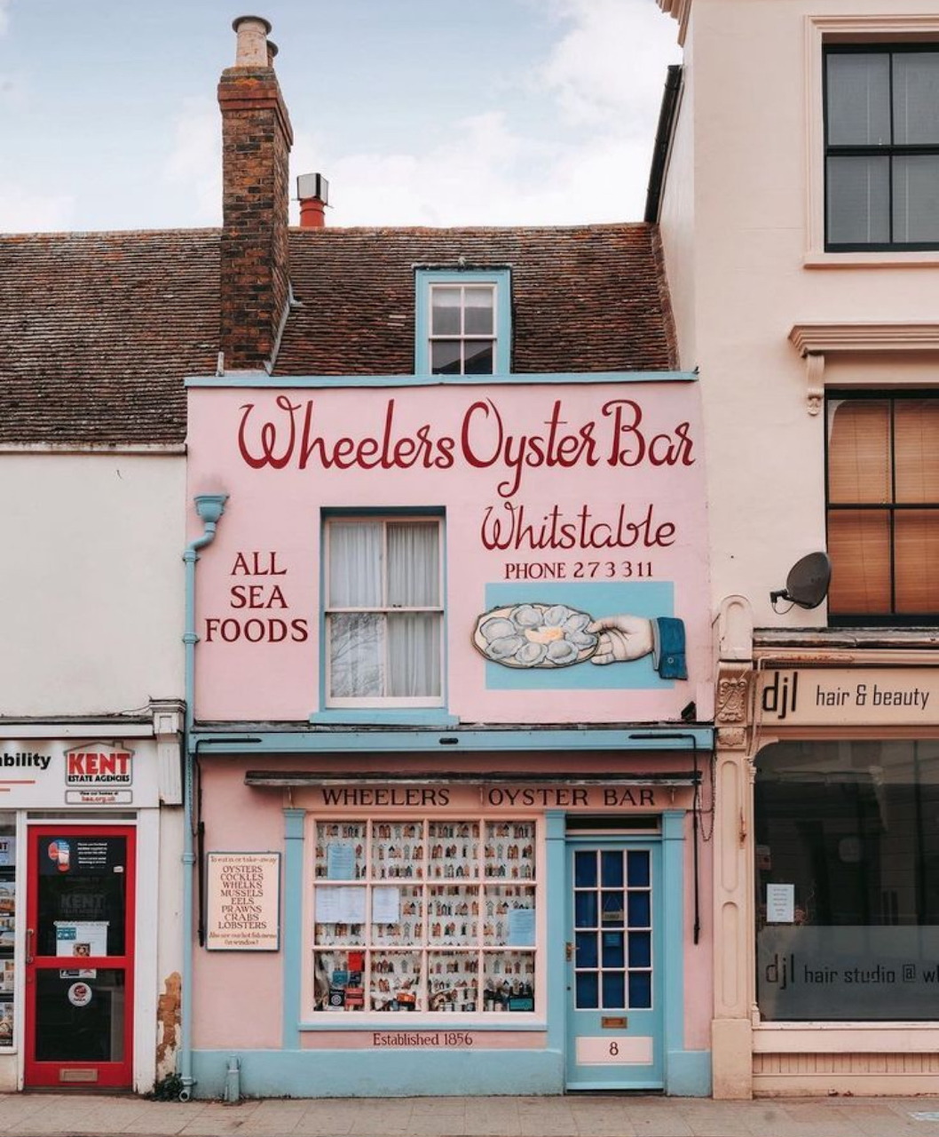 Pink Wheelers Oyster Bar storefront in Whitstable with vintage signage and traditional windows