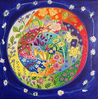 Circular floral mandala with colorful flowers and patterns on blue background surrounded by white daisies