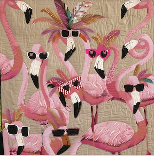 Pink flamingo quilt art with several flamingos wearing sunglasses