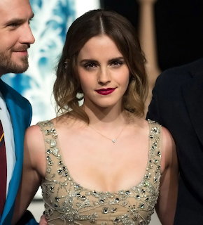 Woman in beaded gown smiling at formal event