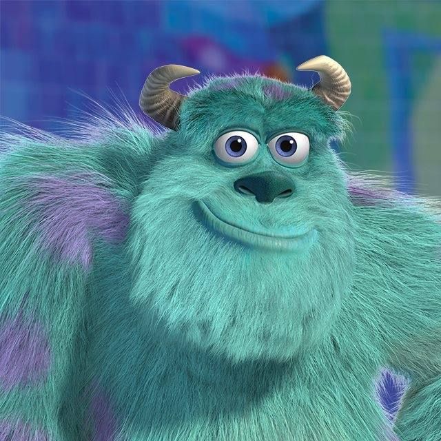 Sulley the turquoise furry monster from Monsters Inc with horns and purple spots smiling