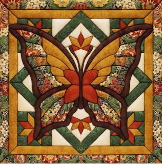 Symmetrical butterfly quilt with autumn leaves and patchwork patterns in warm fall colors