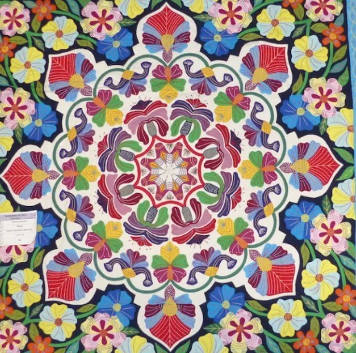 Colorful floral mandala with symmetrical flowers and geometric patterns on a dark background