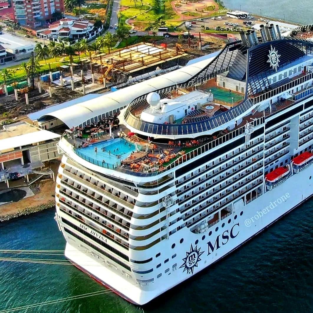 Aerial view of an MSC cruise ship docked at a port beside the terminal