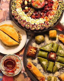 Assorted Turkish sweets including baklava, Turkish delight, and colorful candies on platers with tea
