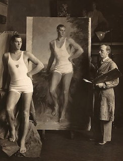 Vintage black and white photo of a male artist painting a woman in a swimsuit posing beside his canvas