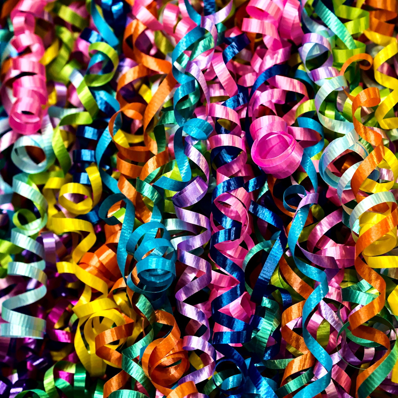 Close-up of colorful curled party streamers filling the frame