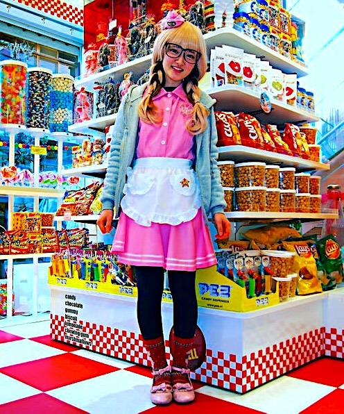 Woman in pink Harajuku fashion outfit with glasses in colorful Japanese toy store