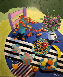 Colorful still life painting with striped table, coffee cup, vase of pink flowers, and patterned decorative items