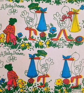 Vintage baby shower gift wrap with storks and babies in repeating pattern