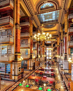 Ornate multi-story law library with balconies, bookshelves, chandeliers, marble columns and skylights