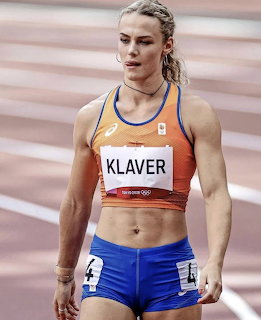 Female sprinter Lieke Klaver wearing orange Netherlands athletic top and blue shorts on a running track