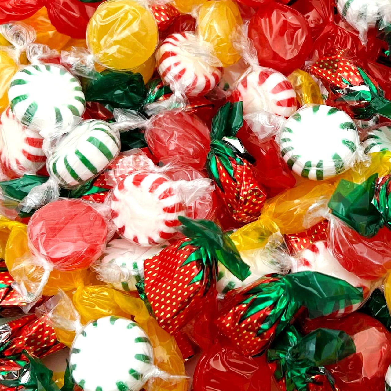 Assorted wrapped old-fashioned hard candies in red, green, yellow, and white with peppermint swirls and strawberry shapes