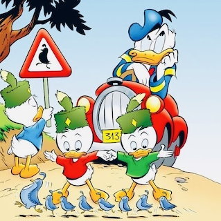 Cartoon ducks crossing a sandy road in front of Donald Duck in a red car