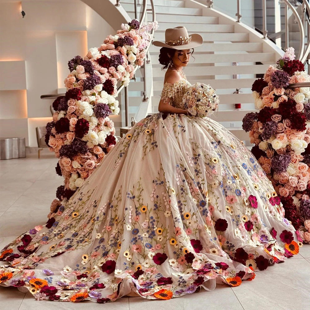 Woman in champagne ball gown with floral details and train under flower arch