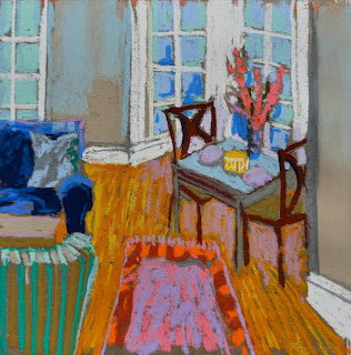 Chalk pastel drawing of colorful living room corner with orange tablecloth, patterned rug, blue sofa, windows and dining area