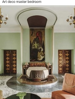 Art deco master bedroom with arched alcove, classical mural, geometric wood paneling, and marble floor