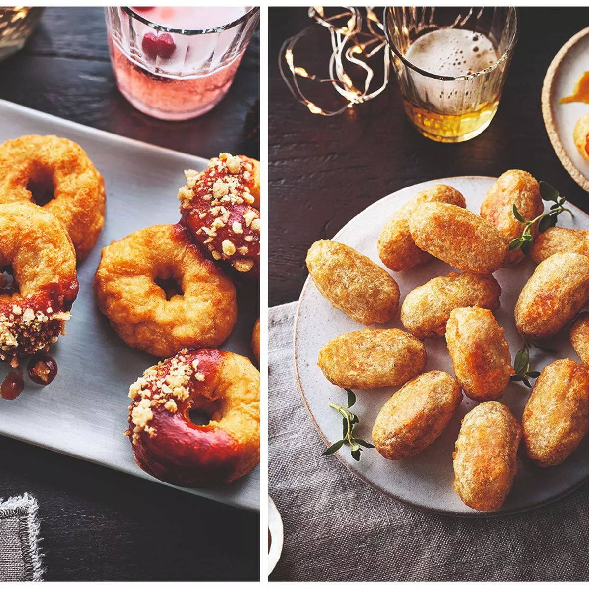 Overhead view of assorted donuts and fried pastries on plates with beverages on dark wood table