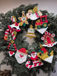 Christmas wreath with colorful needlepoint ornaments on evergreen branches