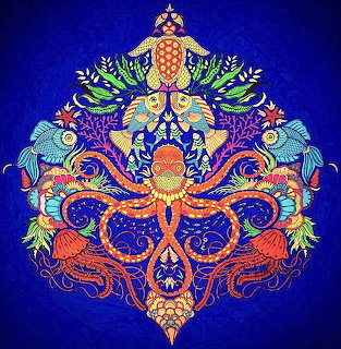 Colorful symmetrical mandala featuring octopus, fish, sea turtle and jellyfish in ornate decorative pattern on blue