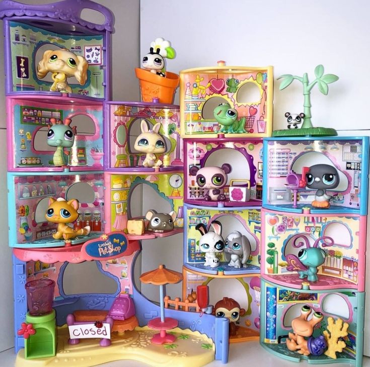 Colorful Littlest Pet Shop multi-story playset with various animal figurines in rooms