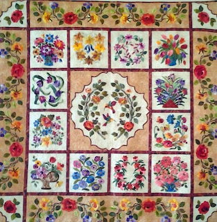 Floral patchwork quilt with rose motifs and colorful flower squares
