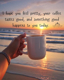 Hand holding white coffee mug on beach at sunrise with inspirational text overlay