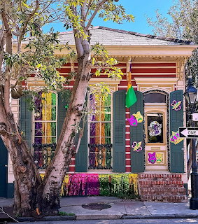 Colorful house with painted shutters, decorations, and flowers in front