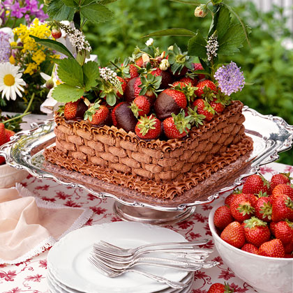 Chocolate cake decorated with fresh strawberries and cream