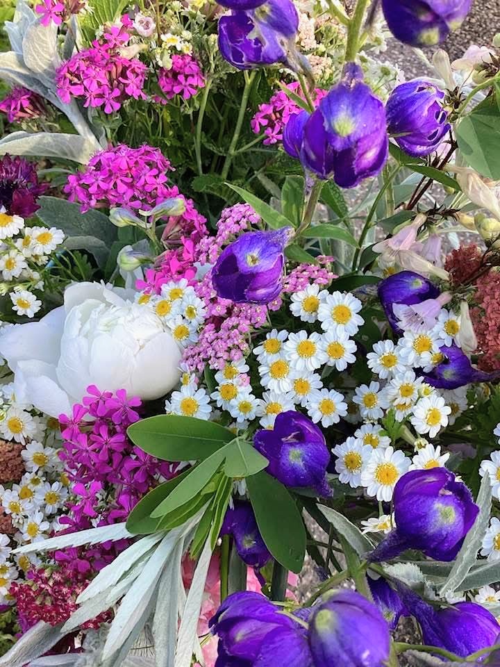 Colorful spring bouquet with purple tulips, pink hyacinths, and white daisies arranged together
