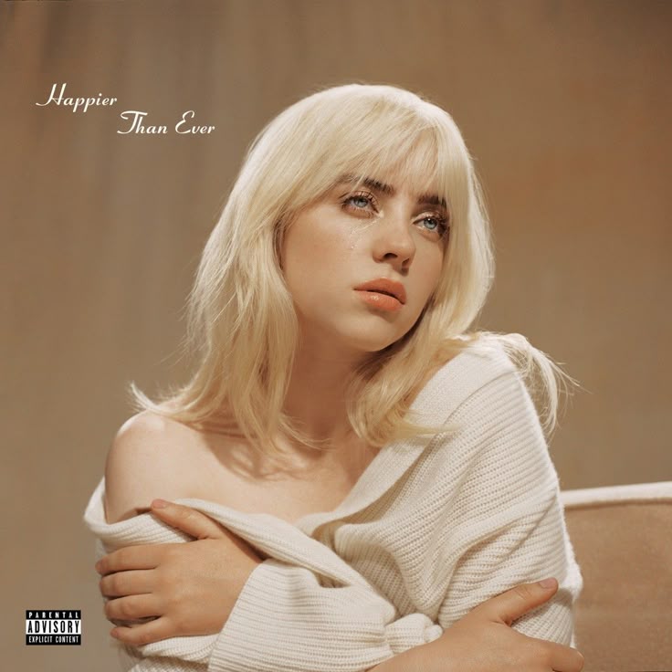 Portrait of woman with platinum blonde hair in off-shoulder cream sweater on beige background