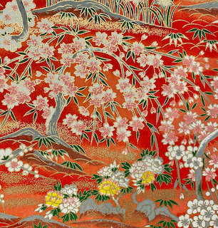 Japanese floral pattern with blossoms and pine branches on a red background