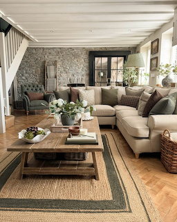 Rustic living room with stone wall, wooden furniture, and beige sectional sofa