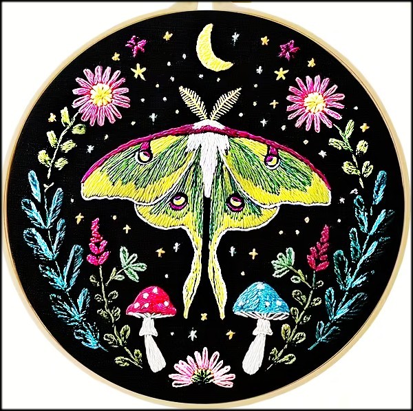 Circular embroidery of a luna moth with flowers, mushrooms, stars, and a crescent moon on black