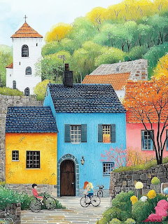 Colorful village houses with tower, autumn trees, flowers and cyclist