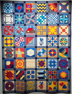 Patchwork quilt with 48 colorful geometric blocks in various star and abstract patterns