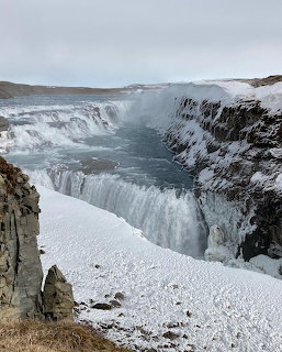 Gullfoss waterfall in Iceland cascading into a canyon surrounded by snow and ice in winter