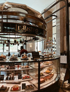 French café table with pastries, coffee cups, and sweet treats in Parisian setting