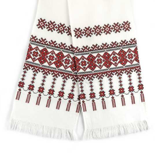 White cloth with red and black Ukrainian geometric embroidery and fringe