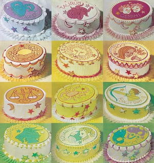 Twelve round cakes arranged in a grid, each decorated with a zodiac sign symbol in various colors